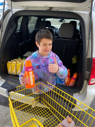A young volunteer loading donated items from Athol Dollar General into a van